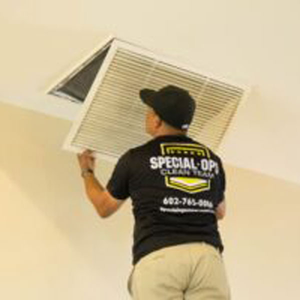 a Special Ops Clean Team technician replacing the air filter of a home in the Phoenix, AZ area