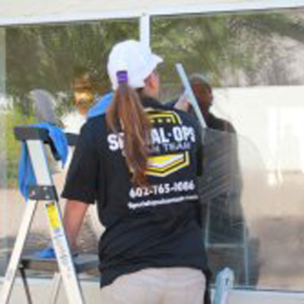 Special Ops Clean Team member washing the exterior of a window in the Phoenix, AZ area